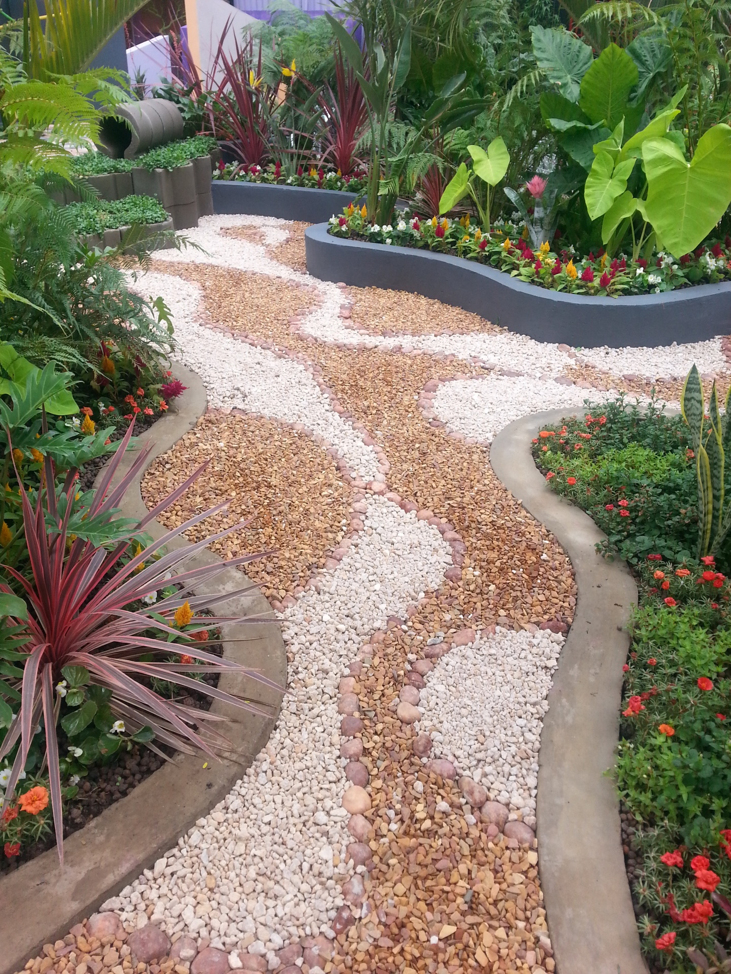 A beautifully articulated garden path using multi-colored stones